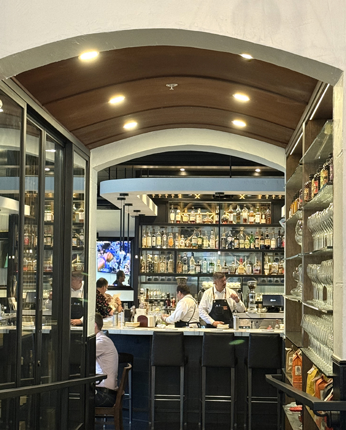 Through the passway to the marble-topped bar.