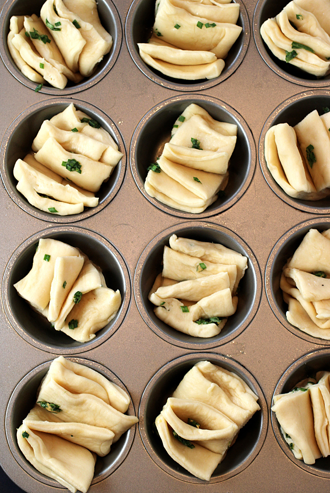 Place the cut squares in the muffin pan, and slightly separate the layers to help form the fantail look.