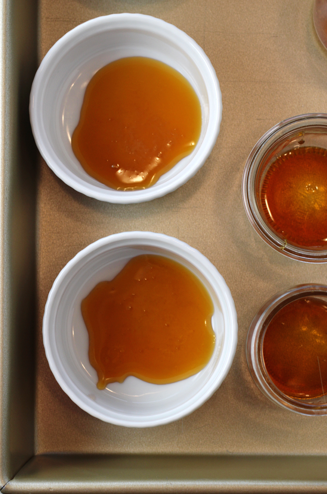 The caramel gets poured into the bottom of the ramekins or glass jars.
