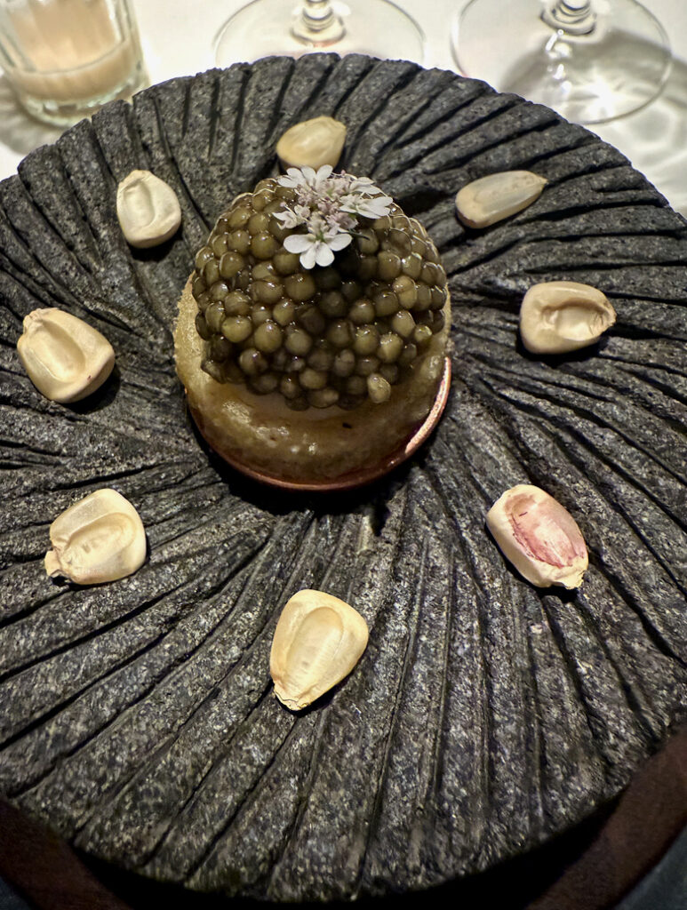 Sope with caviar served on a volcanic rock plate at Californios.