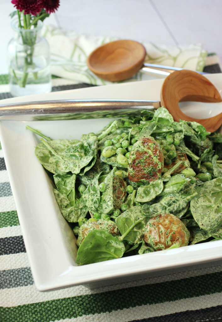 Eat your veggies -- new potatoes with peas, edamame, and spinach in a creamy, herby dressing.