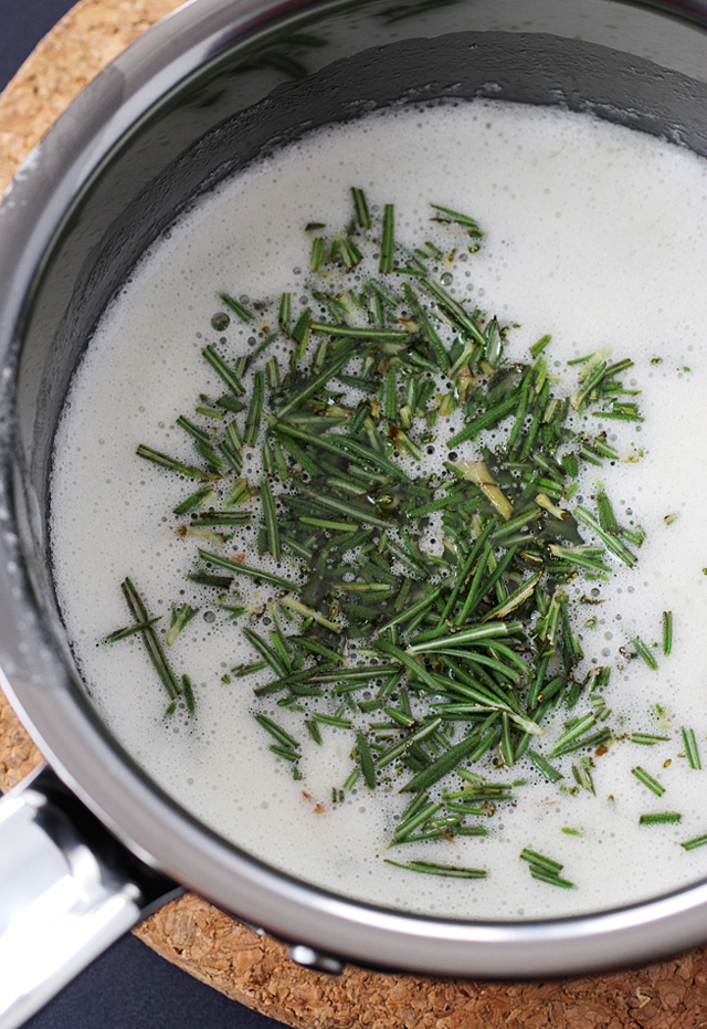 Melted butter is infused with fresh rosemary before being strained.