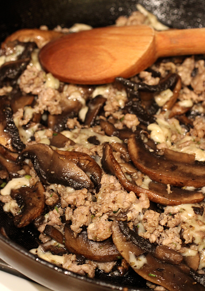 Sauteeing the portobellos with the sausage.
